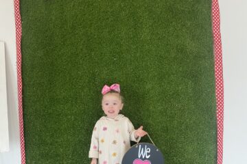 child holding ur smile dental board